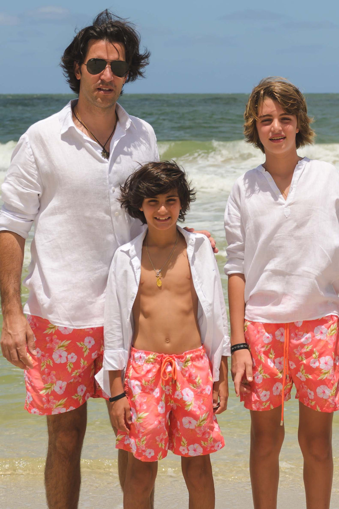 Marido da Maria Rudge e filhos com shorts de banho combinando na praia na estampa exclusiva da Lili Sampedro, Hibiscos Coral 